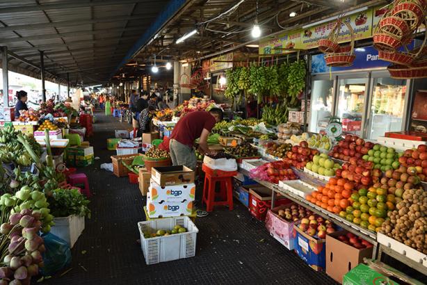 Market stalls, full of fruit and vegetables.