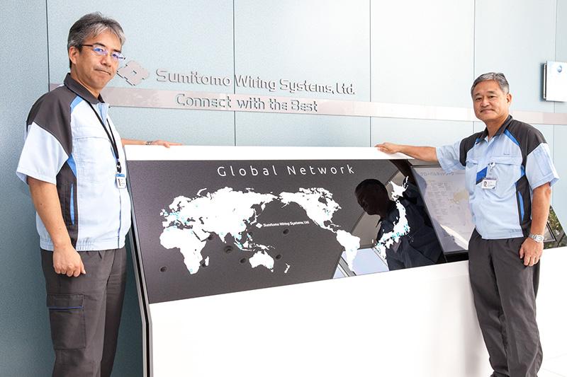 Left) sumitomo electric wiring harness production planning based global flash center leader komori sumitomo denso executive service member akira bo right) pill zhe two mountains