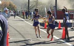 Sash being passed from the first leg runner to the second